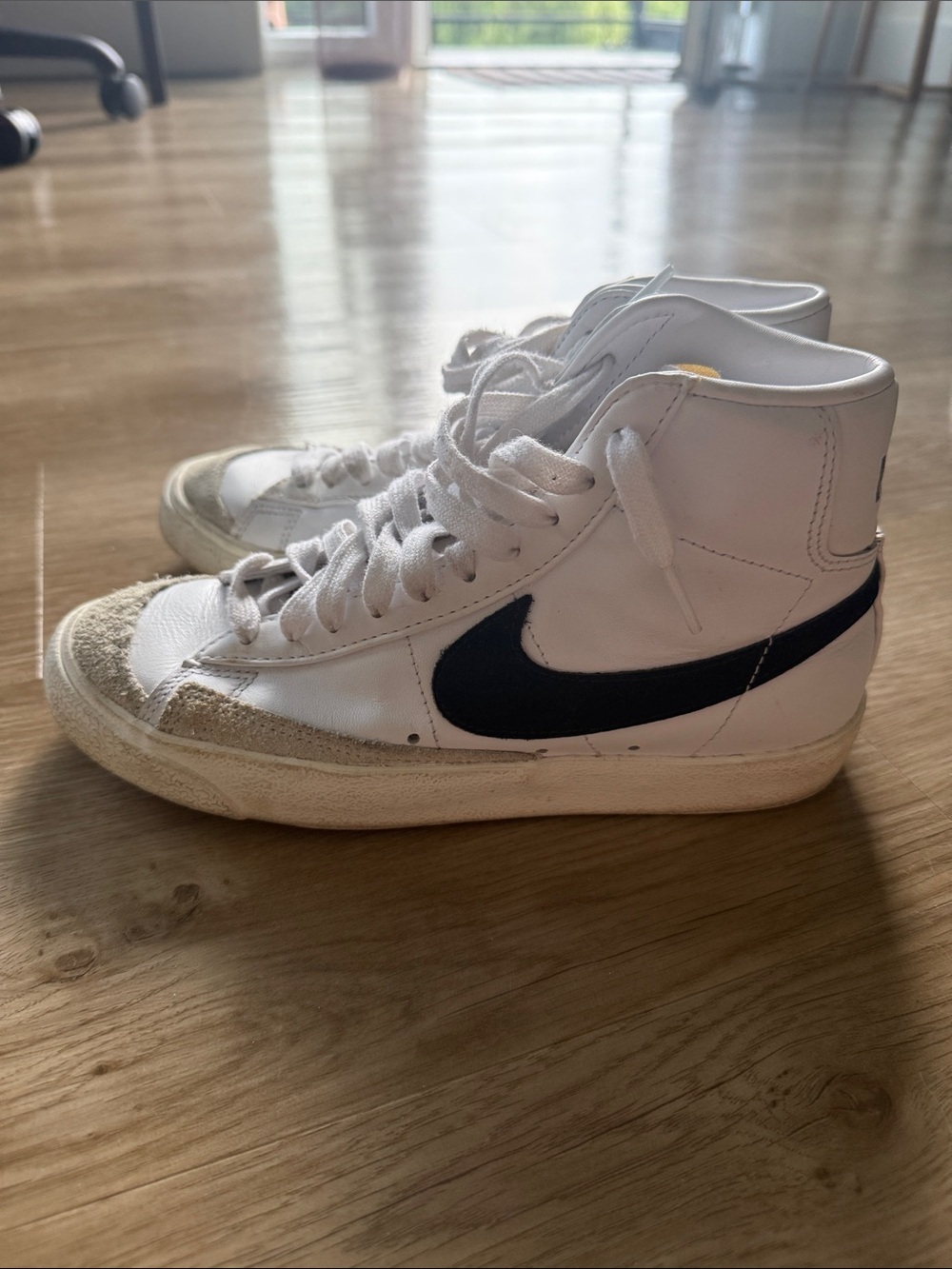 Nike White High-Top Sneakers with Black Swoosh